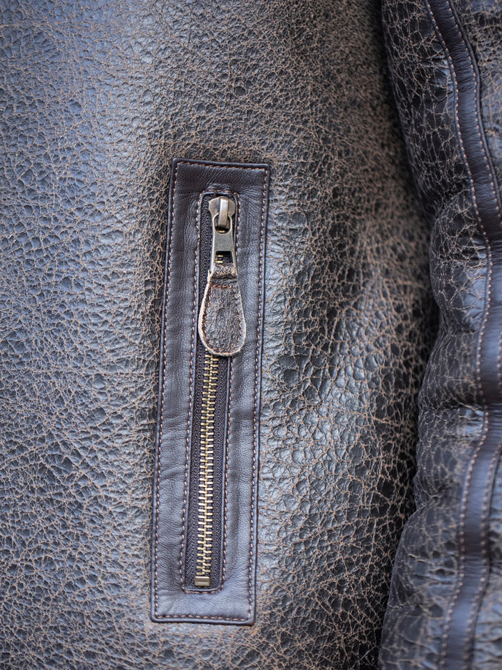 Close-up of a leather Cawfell Shearling Aviator jacket with a zipper detail